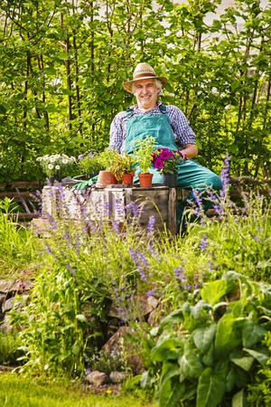 Garden and gardener with straw hat and its plantsの写真素材