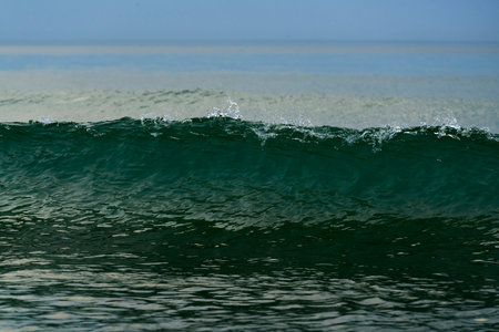 Wave just breaking and having a wave crest with splashes