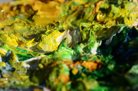 Green oil paint on a dried pallet