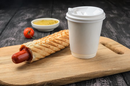 French Hot Dog and coffee on wooden tableの写真素材