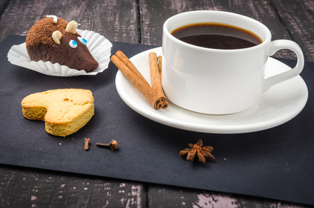 Coffee and sweets on a wooden tableの写真素材