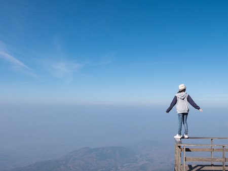 Woman standing on balcony with mountain landscape view at Kio Mae Pan, Chiang Mai, Thailand. Copy Spaceの写真素材