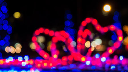 Defocused colorful bokeh light from red bow gift box  Christmas night in cityの写真素材