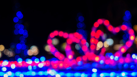 Defocused colorful bokeh light from red bow gift box  Christmas night in cityの写真素材