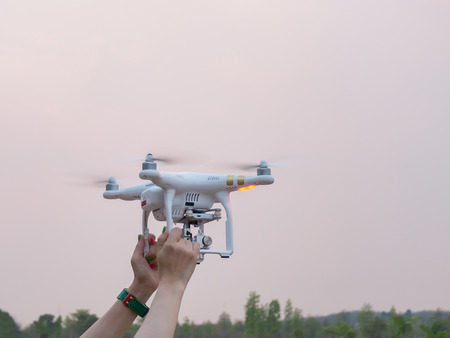 Woman Hand holding Drone at sunsetの写真素材