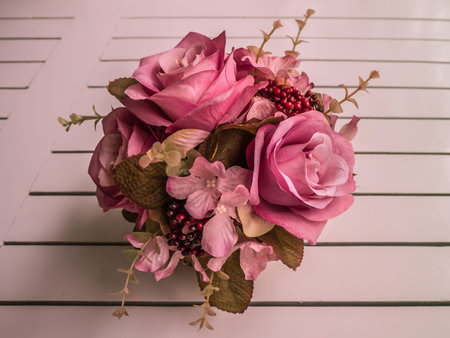 Vintage artificial bouquet on wooden tableの写真素材