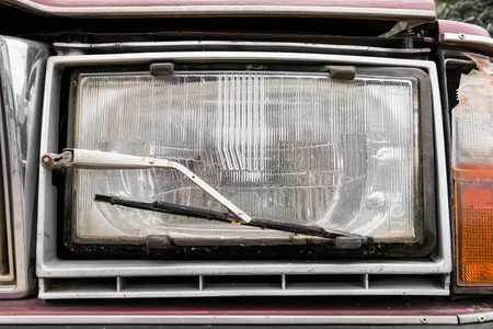 Close up a headlight with a wiper detail on old carの写真素材