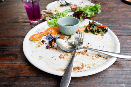 Dirty dish with food scraps and sauce after eat Thai foodの写真素材