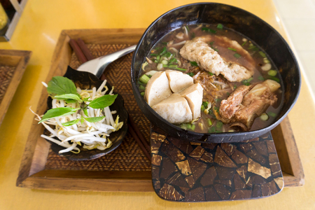 Thai Noodle and big meatball in coconut shells as bowlの写真素材