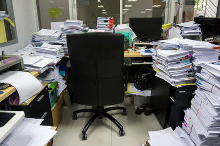 Busy, messy and cluttered workplace, full of documentsの写真素材