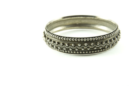 	Silver bracelet isolated on a white background