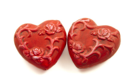  	Two ceramic red hearts isolated on a white backgroundの写真素材