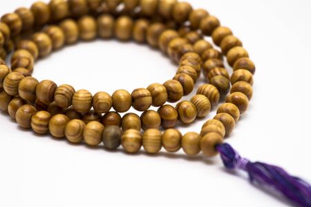 A closeup shot of mala beads made of wood. Prayer beads. Spirit. Religion. Faith.の写真素材