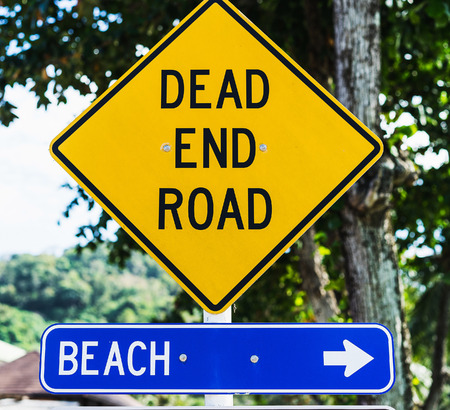 Two signs on the road: "beach" and "dead end road"の写真素材