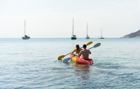 Couple on kayak on the beautiful bay . Back viewの写真素材