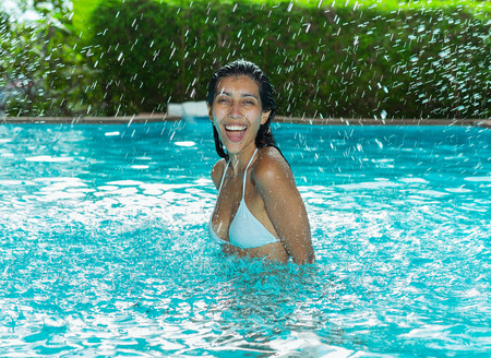 Happy young woman in swimming pool.の写真素材