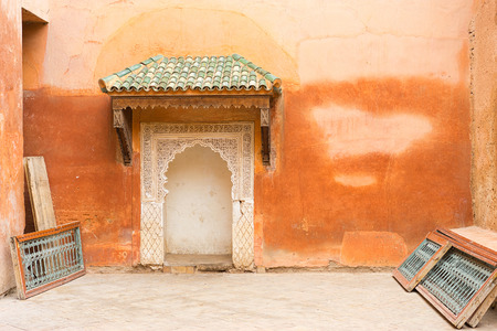Typical decorated Moroccan door with green roof and ethnic handmade decoration. Rough wall with small multicolor port entrance in Arabic style decoration.の写真素材