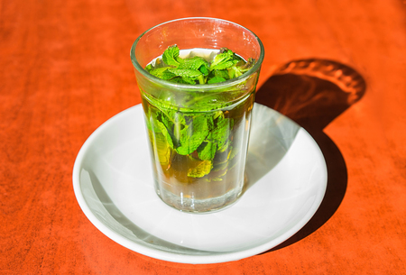 Traditional moroccan mint tea in glass on th table.  Close up photo.の写真素材