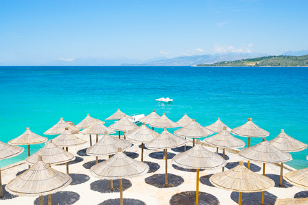 Sunshade umbrellas on the beautiful Ksamil beach, Albania.の写真素材