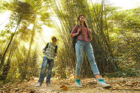 Hikers walking in the jungle. Travel concept.  Focus on the womanの写真素材