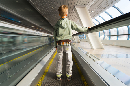 Small boy on escalator in airport. Back view.の写真素材
