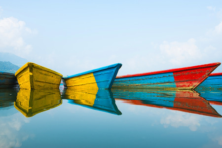 Colorful boats with they reflection on the water.の写真素材