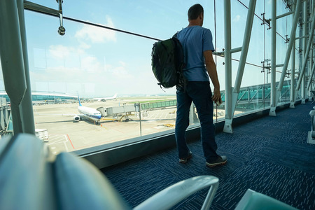 Passenger with backpack and mobile  in airport.の写真素材