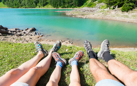 Family: mother, father and son,  resting on the beautiful lake.  Selective focus.の写真素材