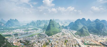 Air view on Yangshuo city with karst mountains around. Yangshuo, China. Banner edition.の写真素材
