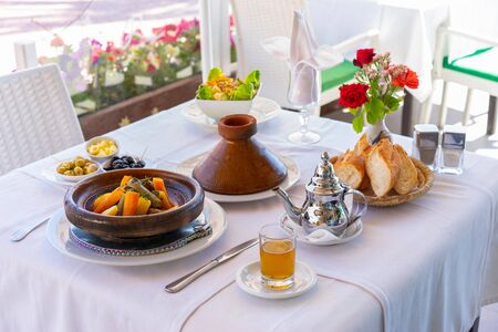 Moroccan food: tajine, mint tea, olive and bread. Focus on tajine.の写真素材