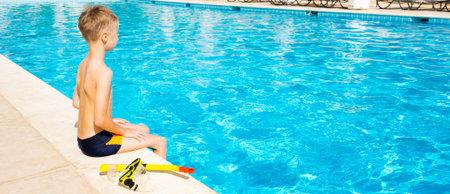 Small boy and snorkeling mask with swimming pool on background. Banner edition.