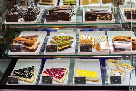 Cakes in the bakery window. Cookies showcase.の写真素材