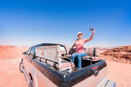 Tourist making selfie on safari in desert Wadi Rum, Jordan.の写真素材