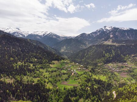 Small villages between beautiful mountains. Aerial panoramic view. Georgia.の写真素材