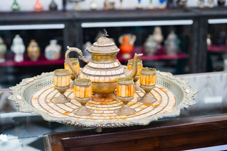 Old traditional arabian teapot and glasses on tray. Selective focus.の写真素材