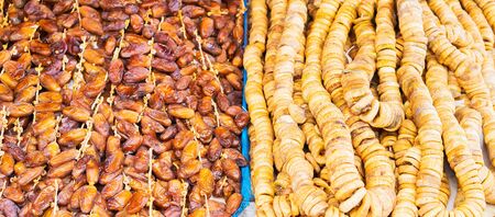 Dried food on the arab street market stall. Figs and dates in shop. Banner edition. Selective focus.の写真素材