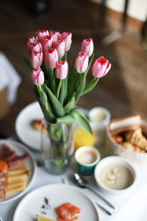 Breakfast in bed, room service. mother's day. Birthday morning. Festive morning. pink tulipsの写真素材