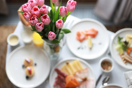 Festive breakfast with pink tulips. room service. Breakfast in bed. holiday morningの写真素材