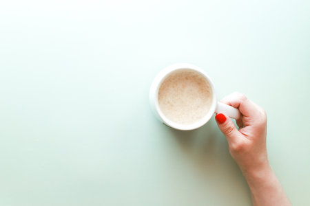 Flat lay hand holding coffee cupの写真素材