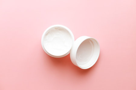 Flat lay cream on pink backgroundの写真素材