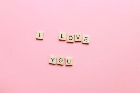 I love you made of wooden letters on a pink background. Flatly i love you. lettering i love youの写真素材