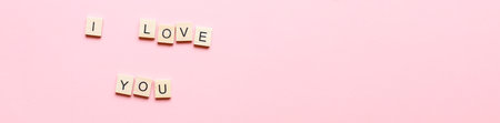 Banner I love you made of wooden letters on a pink background. Flatly i love you. Flat lay valentines dayの写真素材