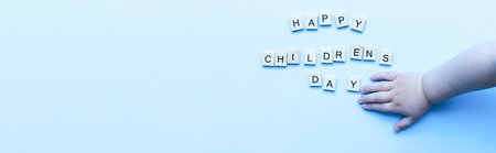 Banner Flat lay happy childrens day on blue background. children's hand. Children Protection Dayの写真素材