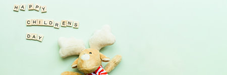 Banner Flat lay Children is Day. Soft toy deer. Children is Day from wooden lettersの写真素材