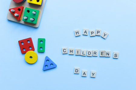 Flat lay happy children is day on blue background. kids toys. children is sorter.の写真素材