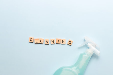 Word cleaning from wooden letters. Spray cleaning. cleaning agent. Purity. Flat cleaning on a blue backgroundの写真素材