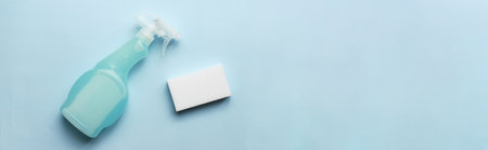 Banner Mockup spray for cleaning. Flatly cleaning spray and sponge on blue backgroundの写真素材
