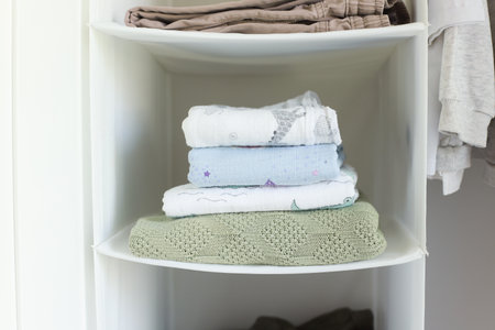 A stack of baby blanket. Muslin film. Knitted baby blanketの写真素材
