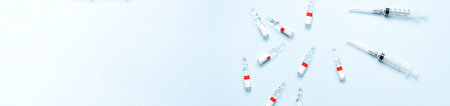 Banner Flat lay ampoules and syringes on a blue background. medical theme. vaccinationの写真素材