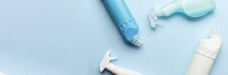 Banner Flat lay different cleaning products on a blue background. clean bottle mockupの写真素材